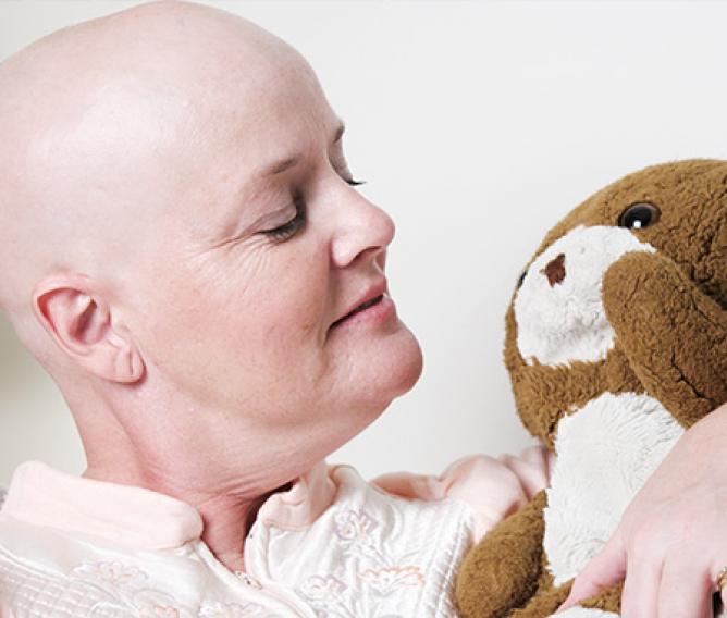 woman recovering from cancer with teddy bear